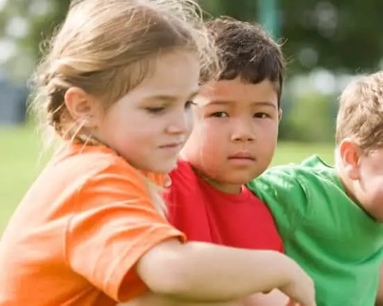 Children sitting in the grass.