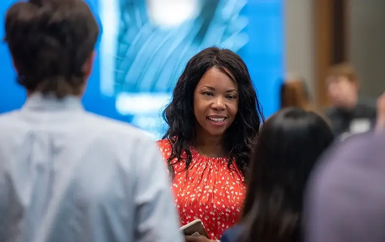 A diverse group of colleagues having a conversation at a business event