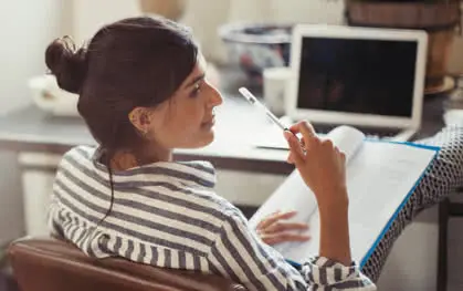 A woman casually working at her desk